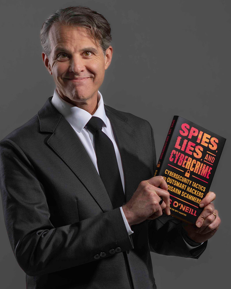 Eric O'Neill with his book, Spies, Lies, and Cybercrime